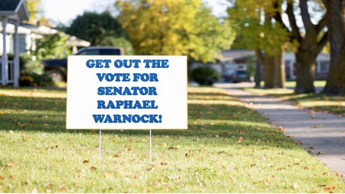 Residential scene with yard sign: “Get out the vote for Senator Raphael Warnock!”