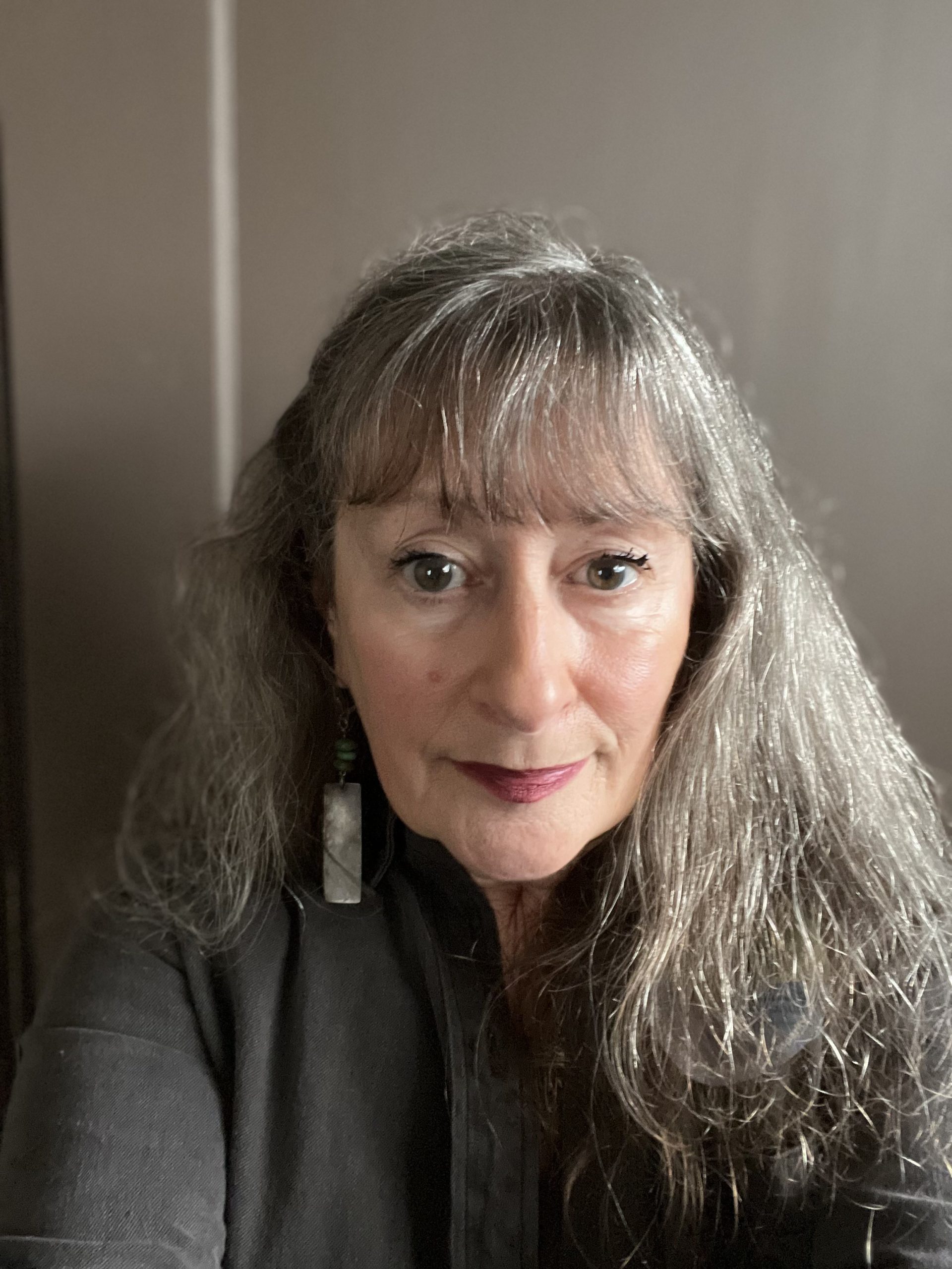 Cindy Abbott for Pacifica City Council District 3. Woman with long hair and bright eyes, looking at the camera. Photo credit: Cindy Abbott, used with permission.