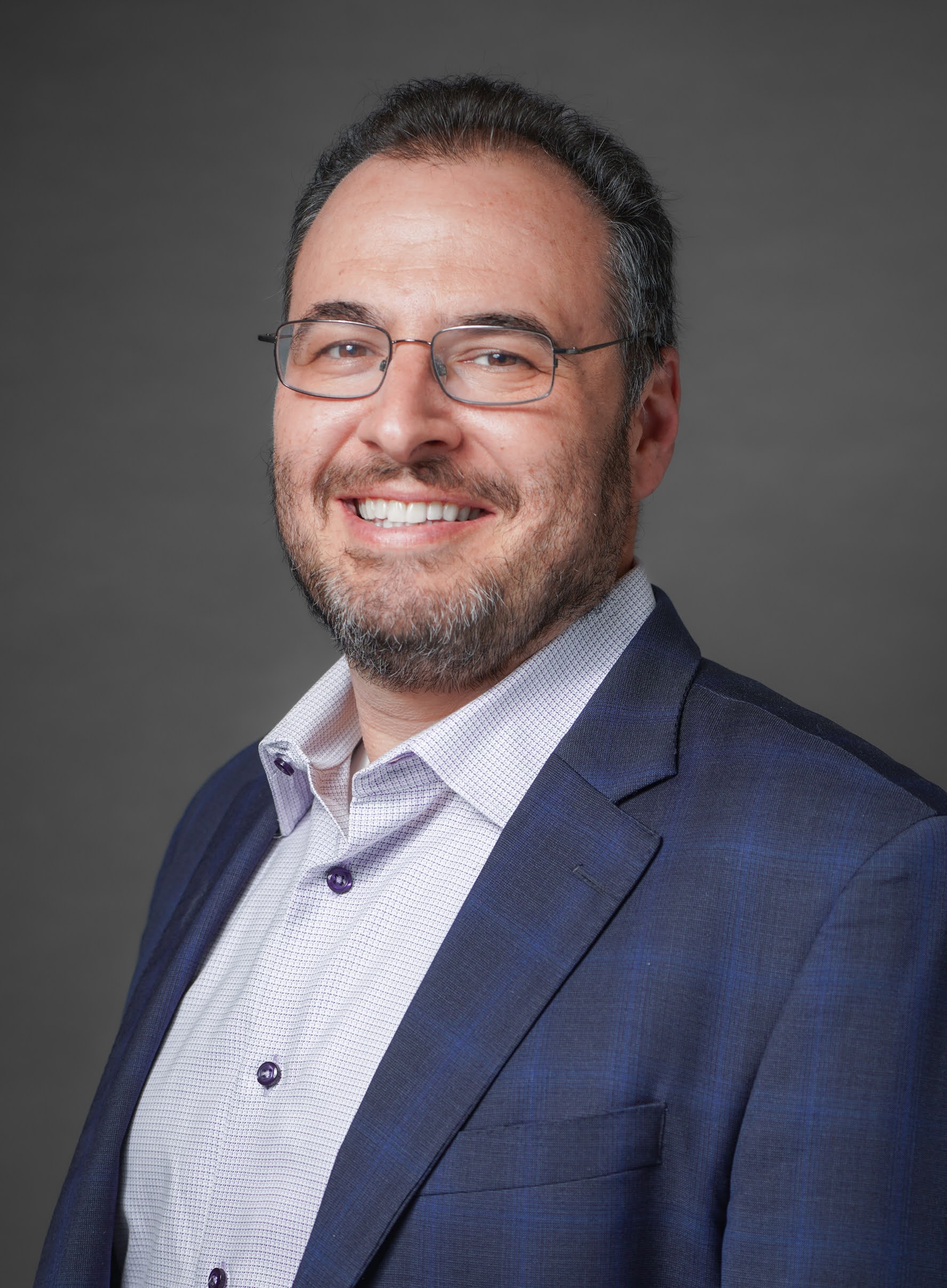 Howard Wettan for Burlingame City Council District 3. Man with short hair, glasses and a trimmed beard smiling at the camera. Photo credit: Howard Wettan, used with permission.