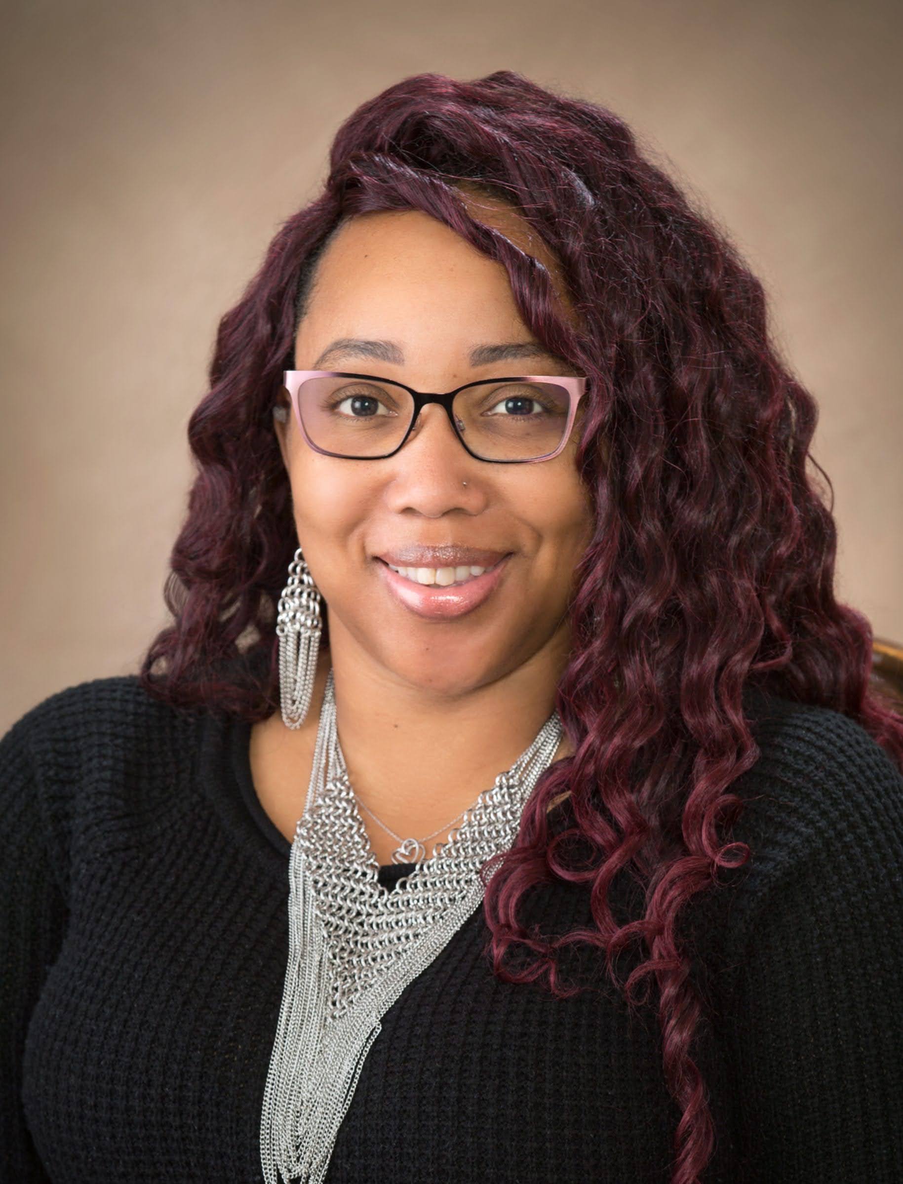 Tamisha Torres-Walker for Antioch City Council, District 1. Woman with long red-brown hair and stylish horn-rimmed glasses. Photo credit: Tamesha Torres-Walker, used with permission