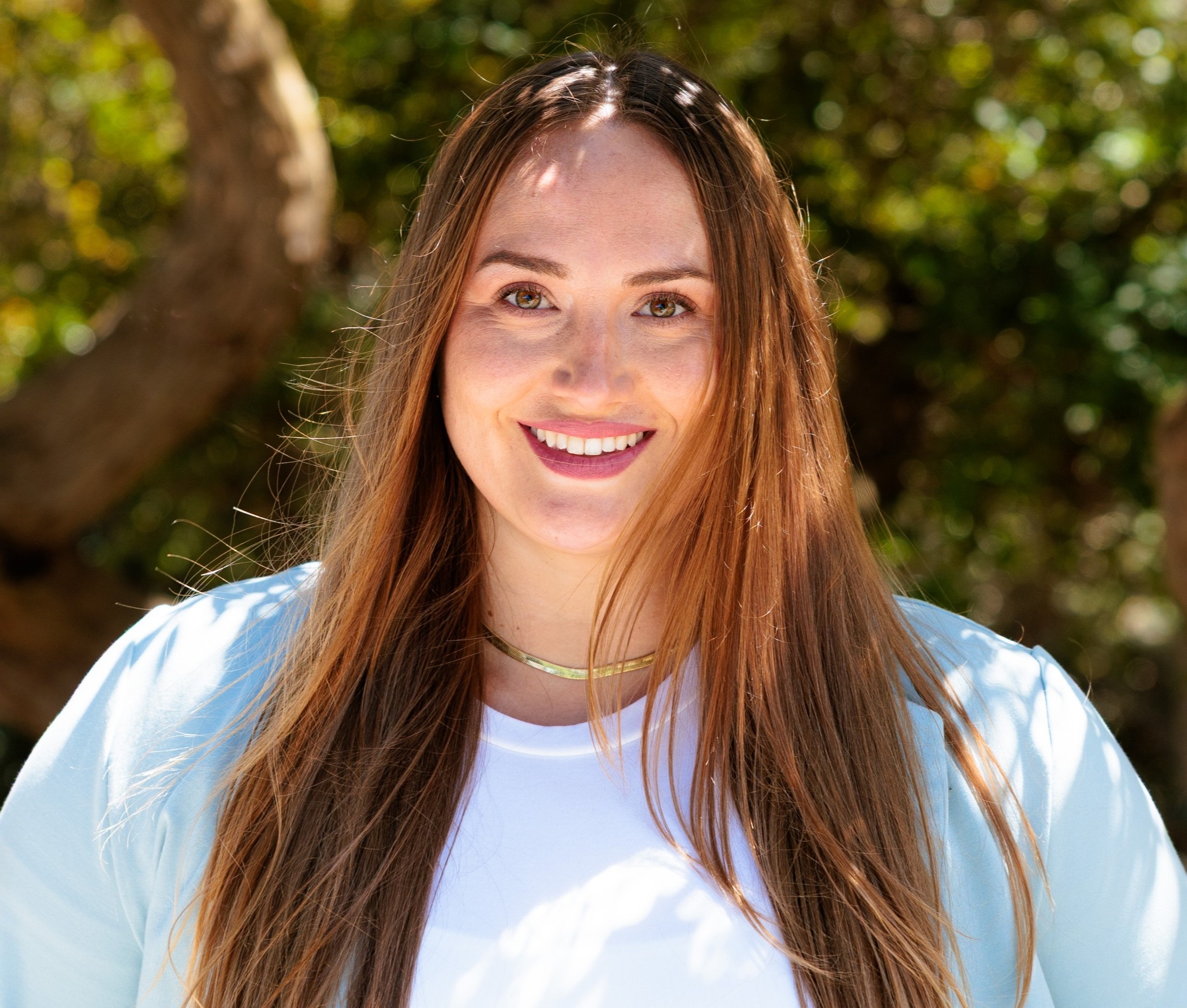 Melanie Olson for South San Francisco District 3. Long-haired woman with red-brown hair and big smile. Photo credit: Melanie Olson, used with permission.