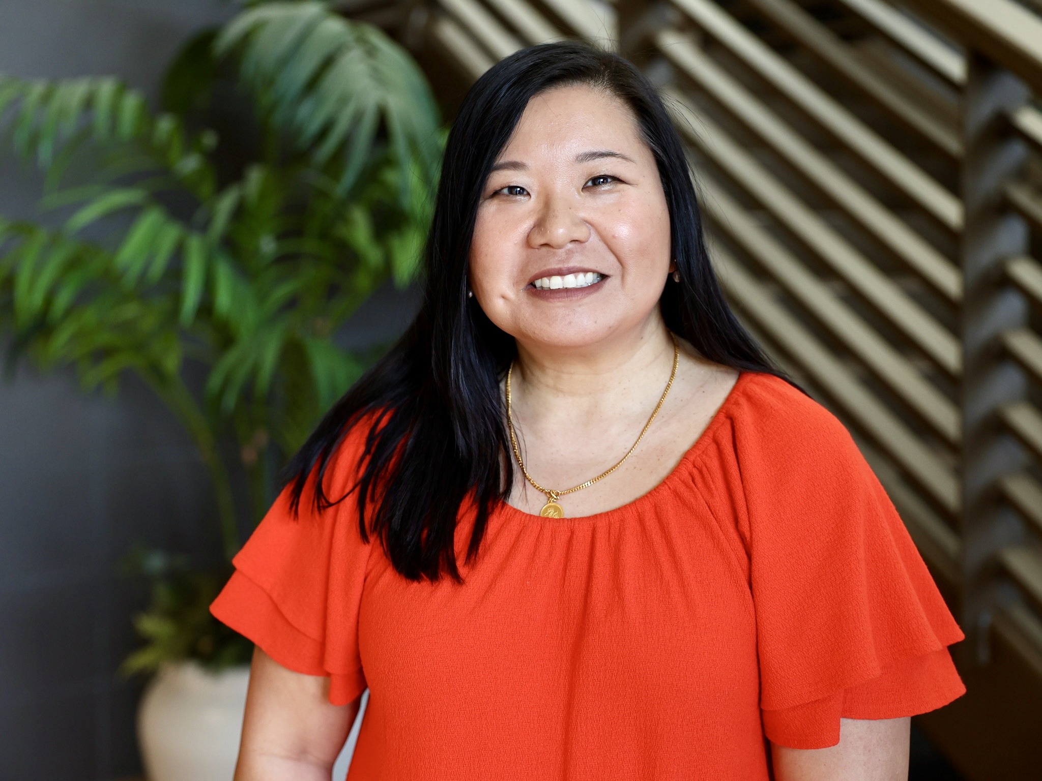 Picture of woman in orange top smiling